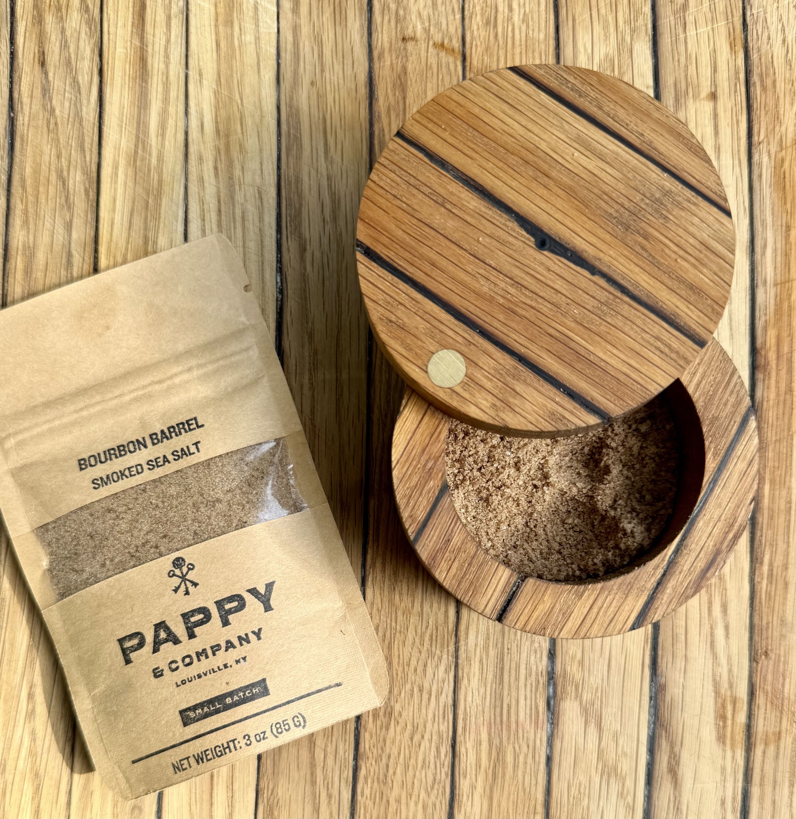 Pappy & Company smoked sea salt packaging with wooden container on a wooden surface